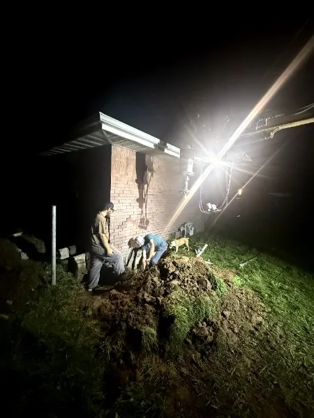 GreyLine crew working on a foundation after dark under work lights