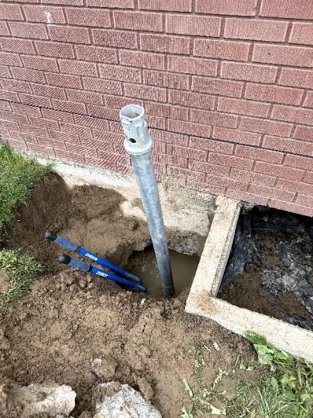 Steel pier installed at the foundation of a brick home